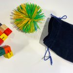 Fidget toys in a blue velvet drawstring bag