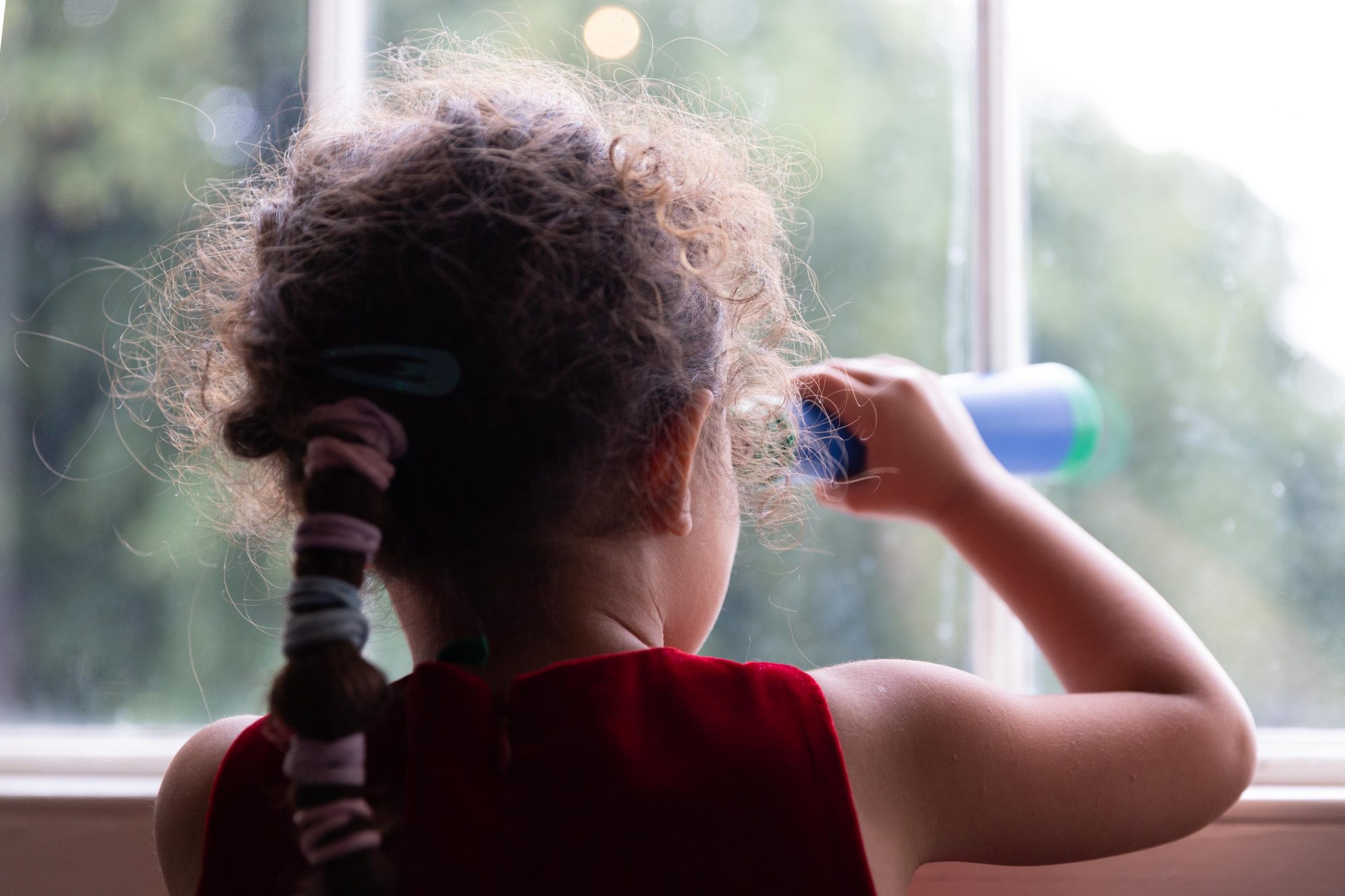 Visitor using telescope from the sensory bag at the museum window